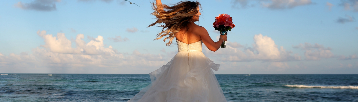 happy dancing bride spinning in her Matthew Christopher wedding dress with hair flying Iberostar Paraiso del Mar Wedding