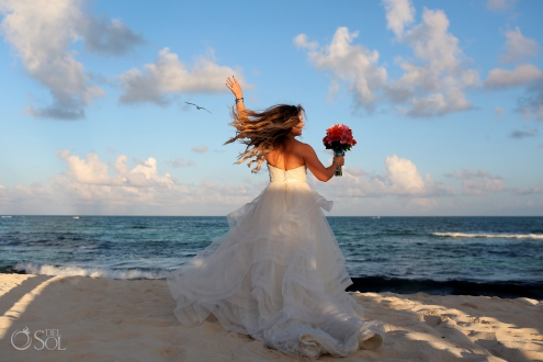 happy dancing bride spinning in her Matthew Christopher wedding dress with hair flying Iberostar Paraiso del Mar Wedding