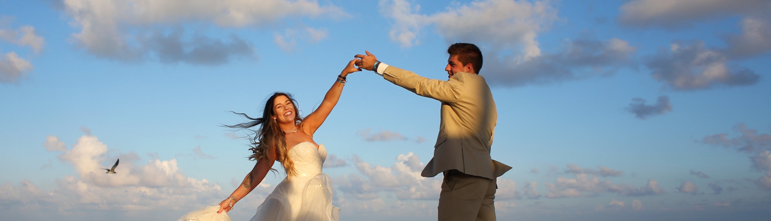 Sunset portrait happy dancing Matthew Christopher wedding dress Iberostar Paraiso del Mar Wedding