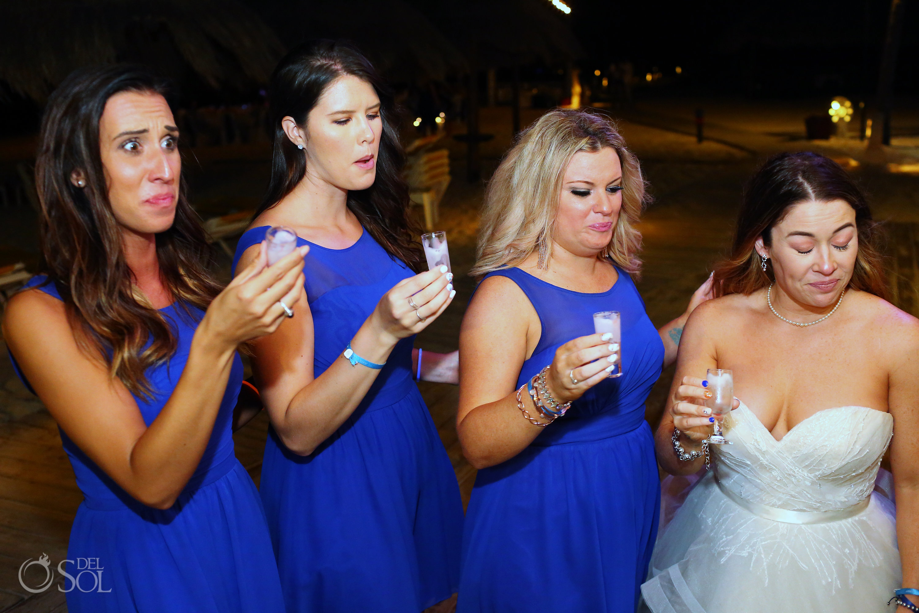 bride and bridesmaids pulling funny faces after drinking shots Iberostar Paraiso del Mar Wedding Reception