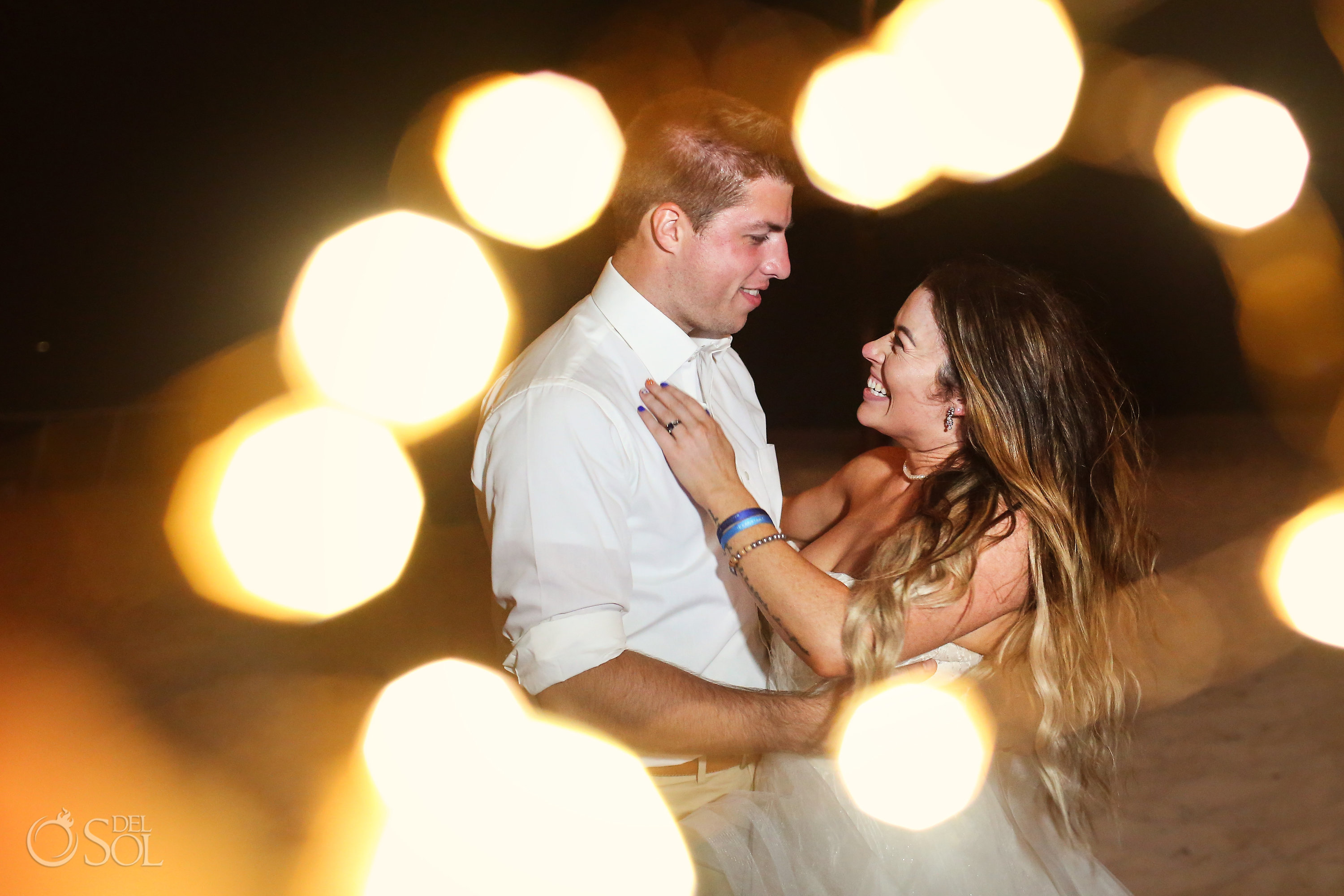 Candid portrait of bride and groom laughing with fairy lights Iberostar Paraiso del Mar Wedding Riviera Maya