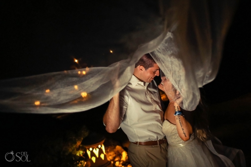 bride and groom portrait laughing under long bridal veil Iberostar Paraiso del Mar Wedding