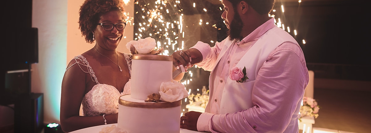 African american couple cutting wedding cake Sky Terrace Hyatt Ziva cancun