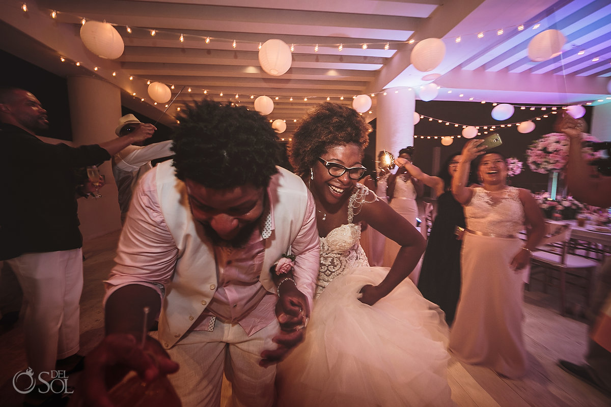 Bride and Groom running through wedding sparklers sky Terrace Hyatt Ziva Cancun