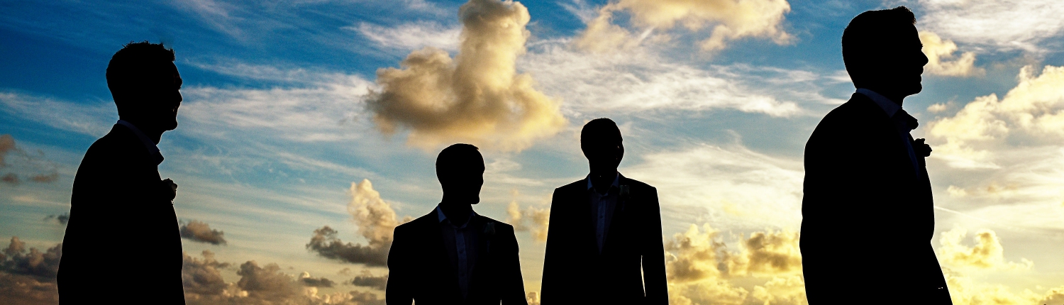 Grooms Party silhouette portrait dramatic sunset sky funny clouds Secrets Silversands Cancun Wedding