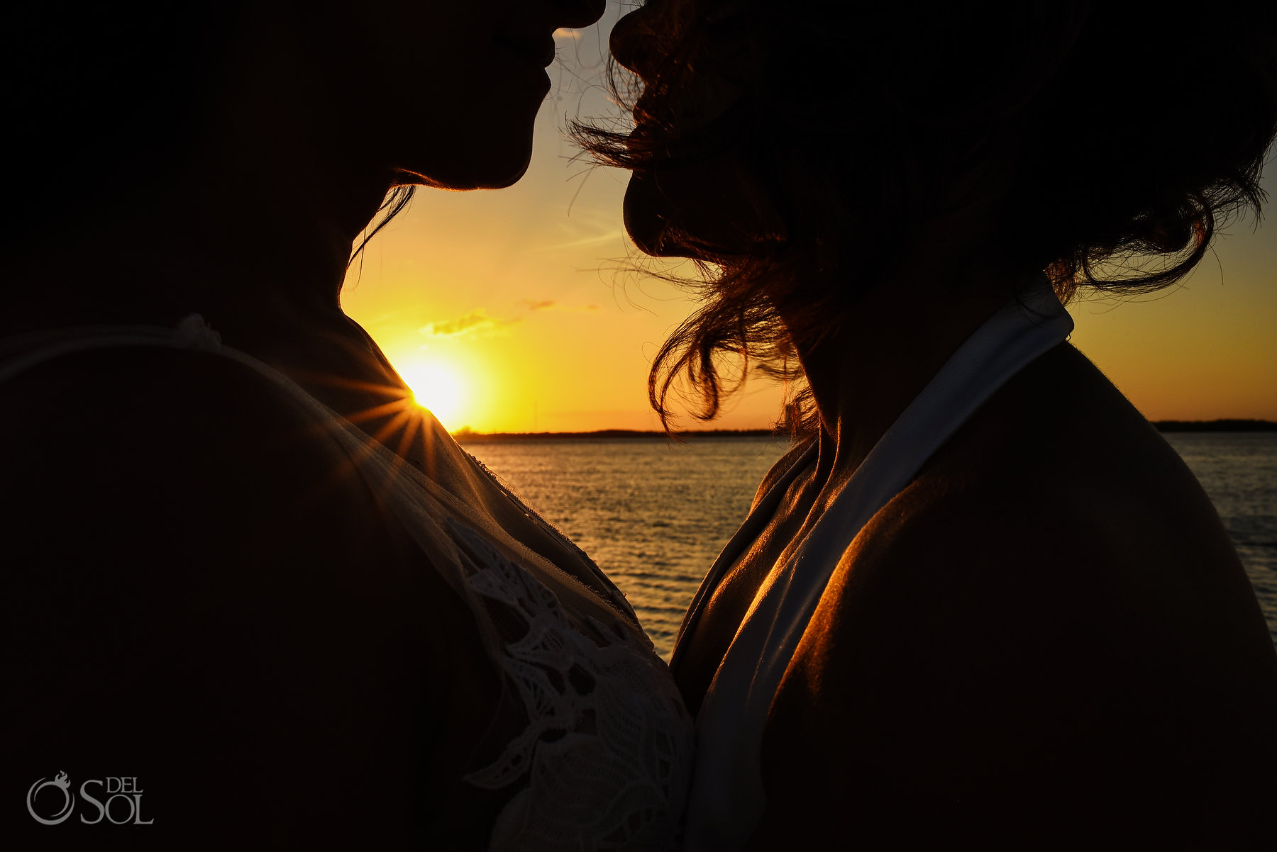 intimate lesbian bridal sunset silhouette photo Same Sex Nizuc Wedding