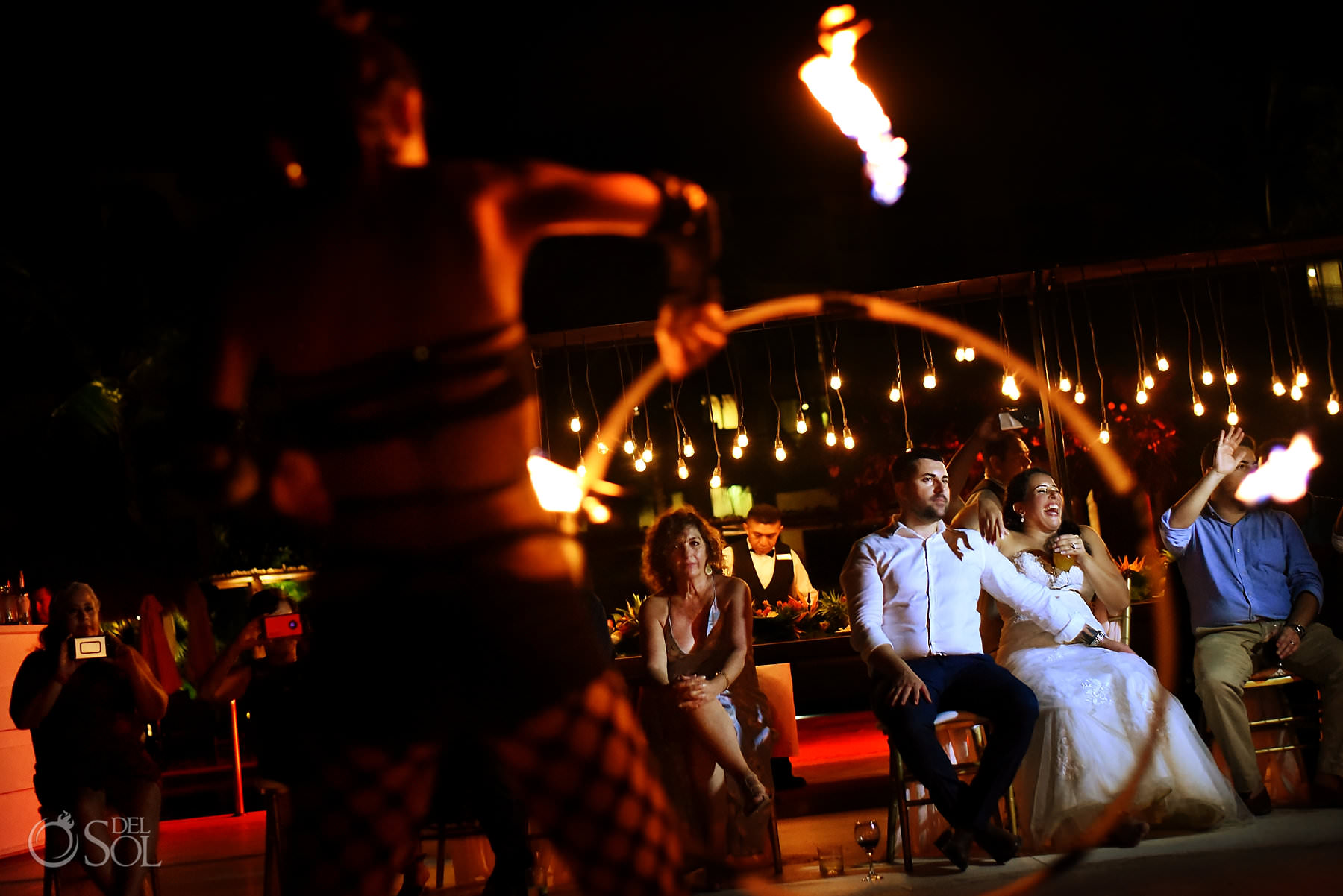 Bride and groom enjoying fireshow Dreams Riviera Cancun wedding reception
