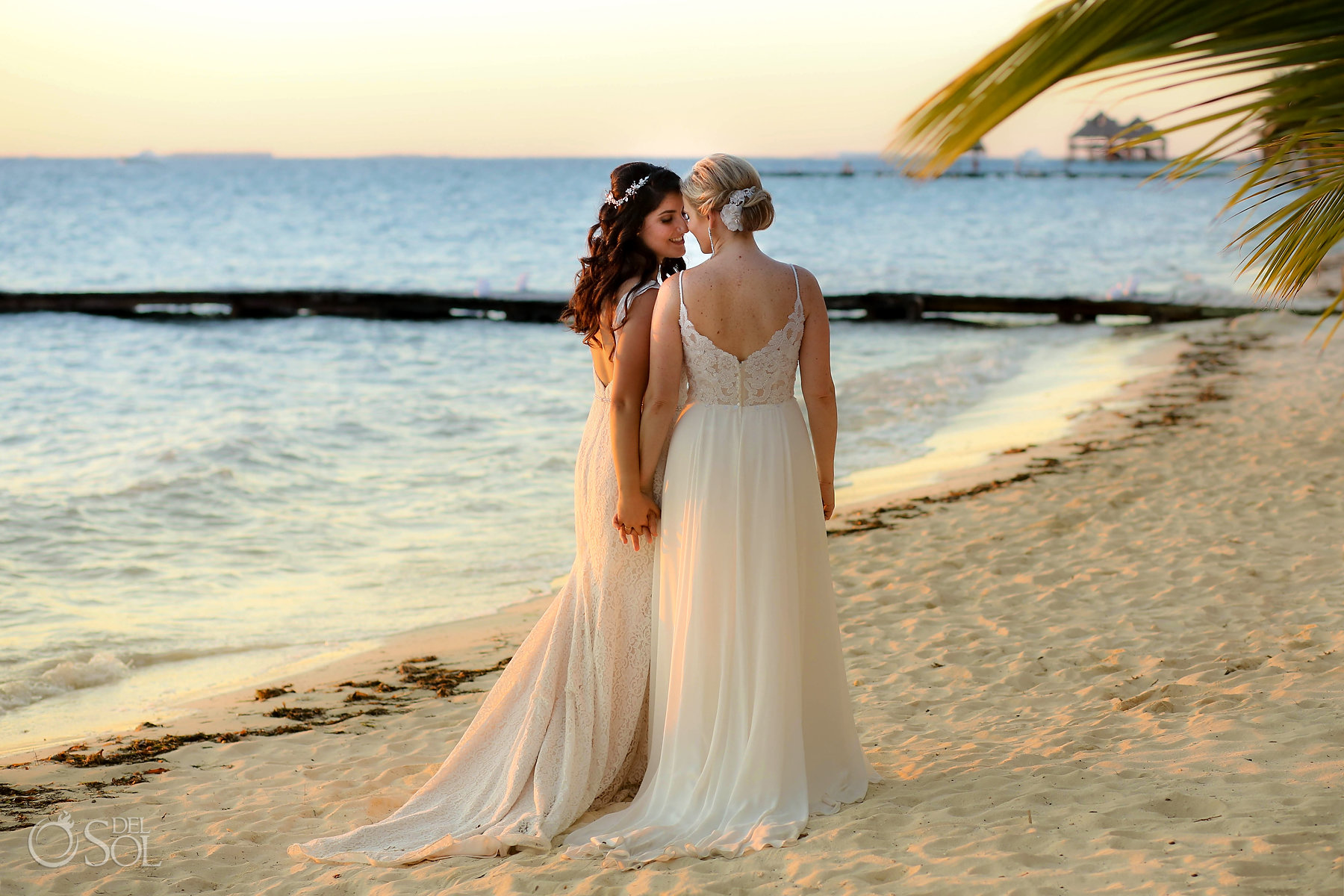 Lesbian Brides in long white Mikaella Bridal Gown