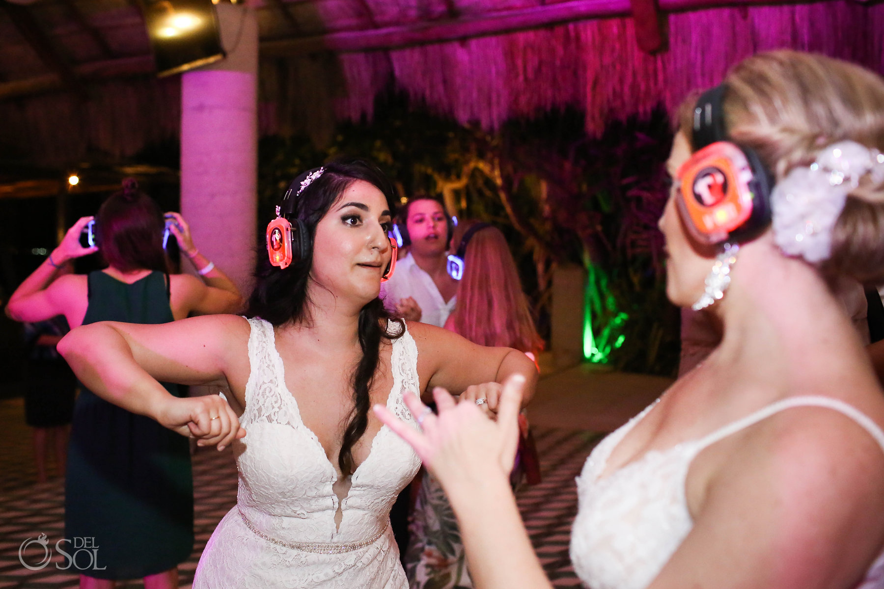 Queer Brides dancing at silent disco wedding reception Isla Mujeres Zama Beach