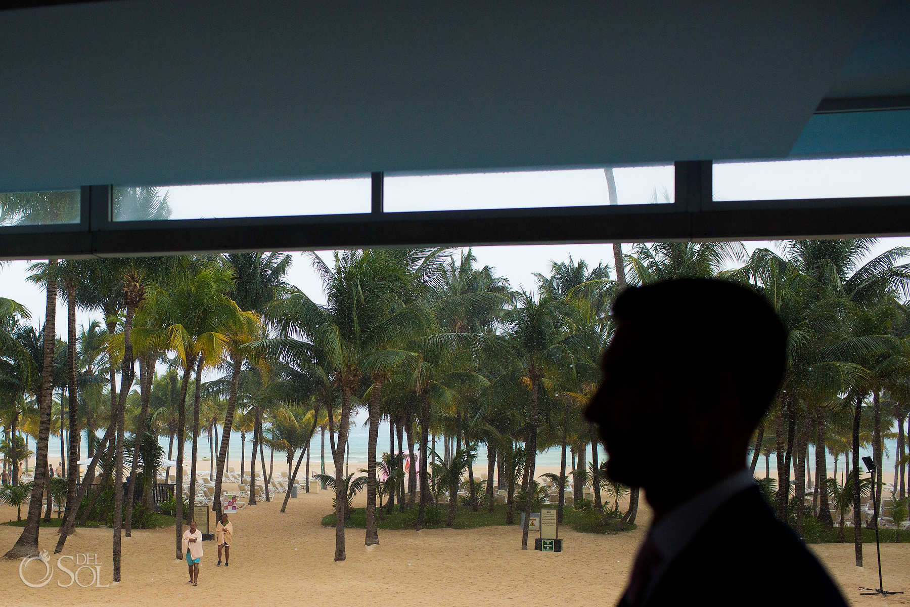 raining on wedding day Groom silhouette at the Riu Palace Mexico photographer