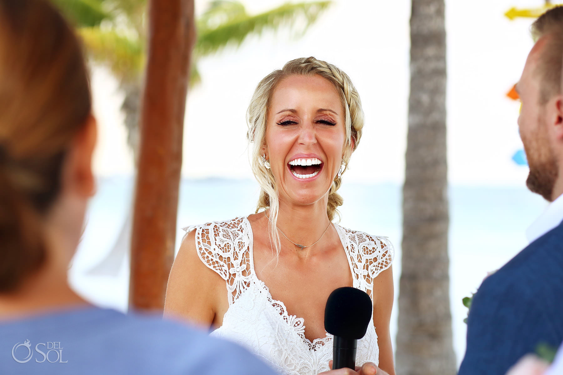 Bride laughing beach ceremony wedding 