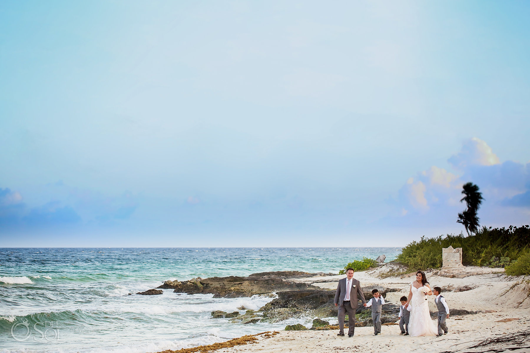 Lifestyle wedding portraits Hotel Xcaret Mexico bride groom and children walking in the beach