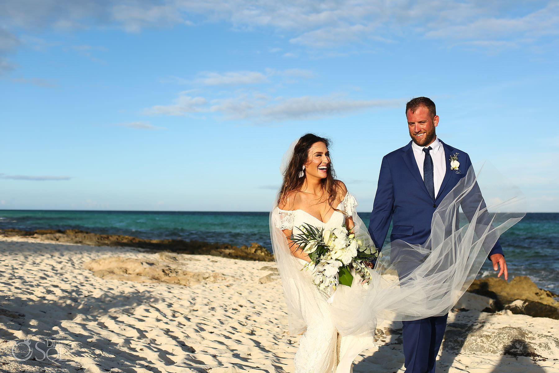 Candid portrait bride and groom walking on the beach hotel Xcaret mexico