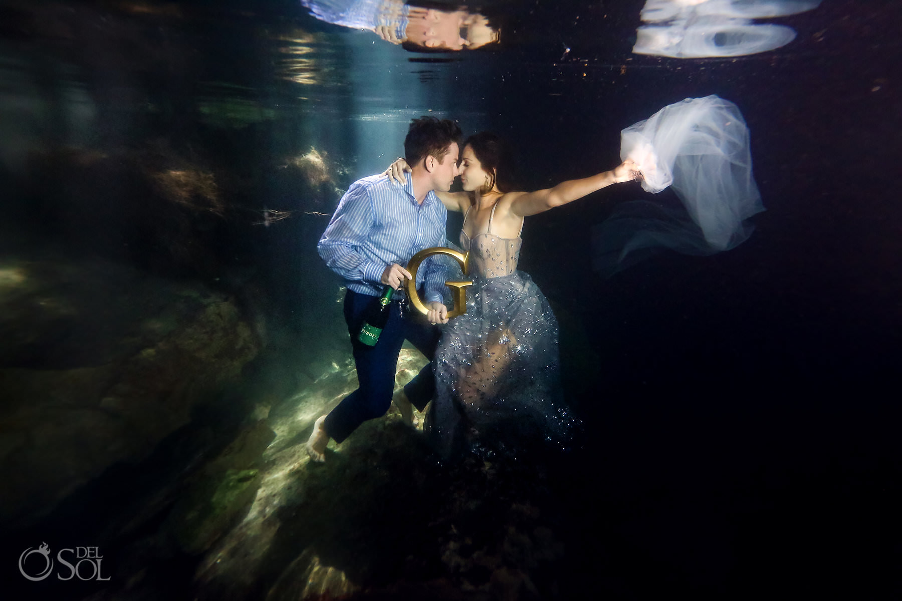 Bride and groom together underwater eloping in cenotes in mexico