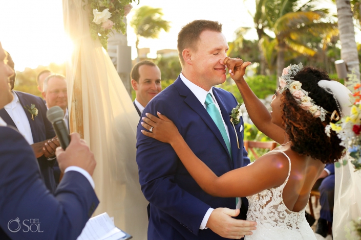 adorable wedding moment bride touches groom's nose sunset beach wedding Hotel Xcaret Mexico