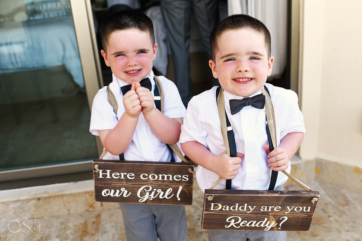 grooms children holding custom wooden wedding signs 