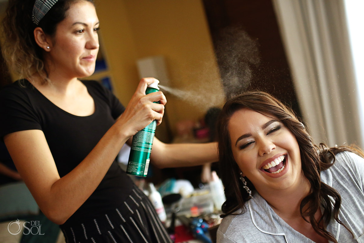 bridal hair and makeup bride laughing with hair spray