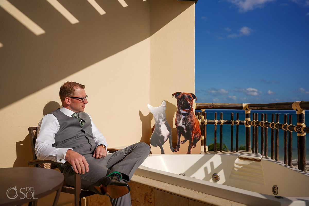 Groom on balcony Dreams Riviera Cancun rooftop terrace wedding