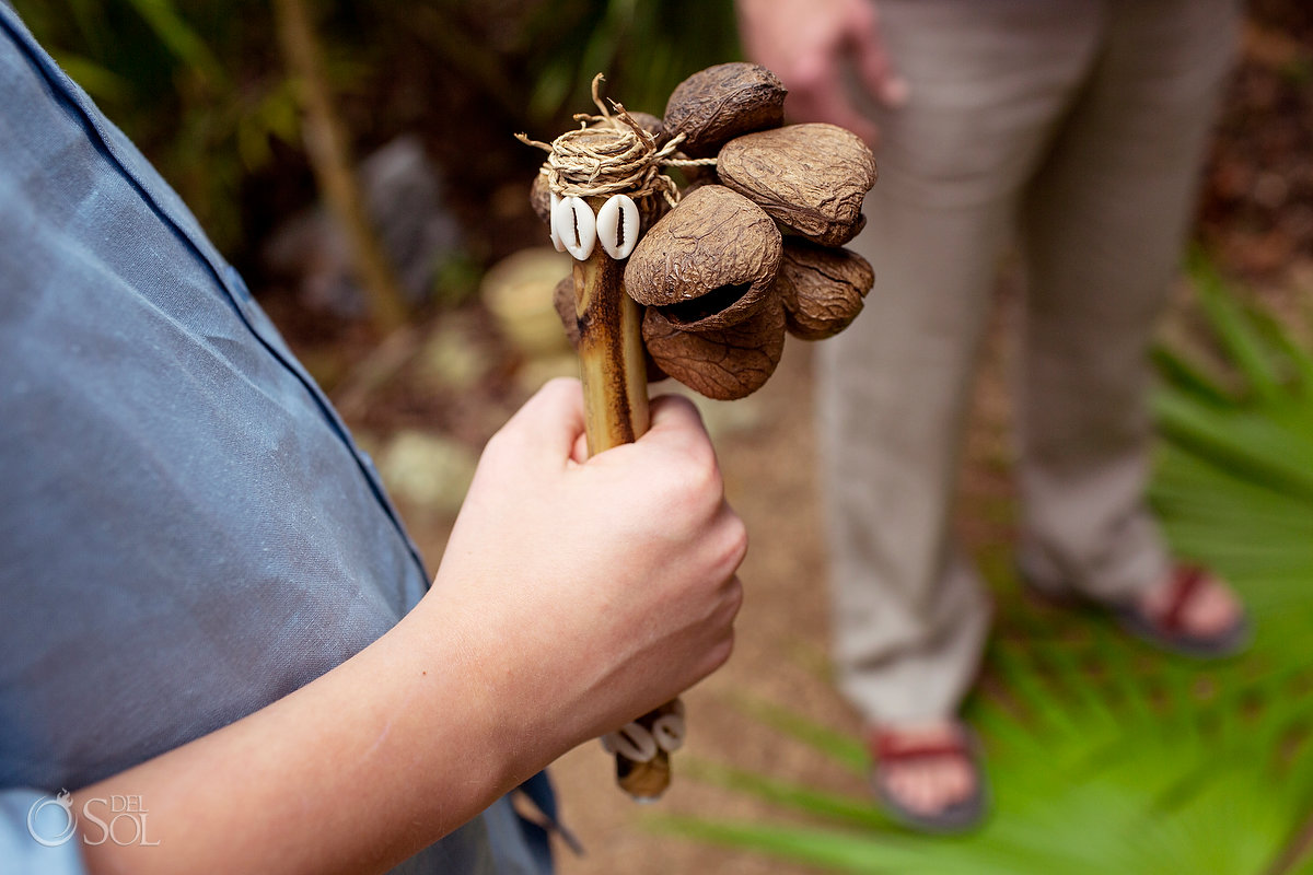 couple's son holds traditinal Mayan musical instrument for spiritual vow renewal ceremony