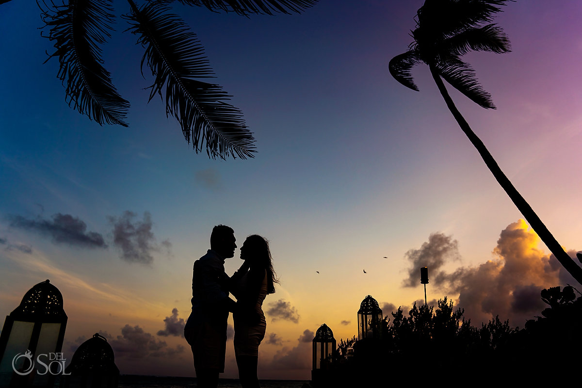 Tulum beach proposal inspiration sunset silhouette with lanterns candles palm trees