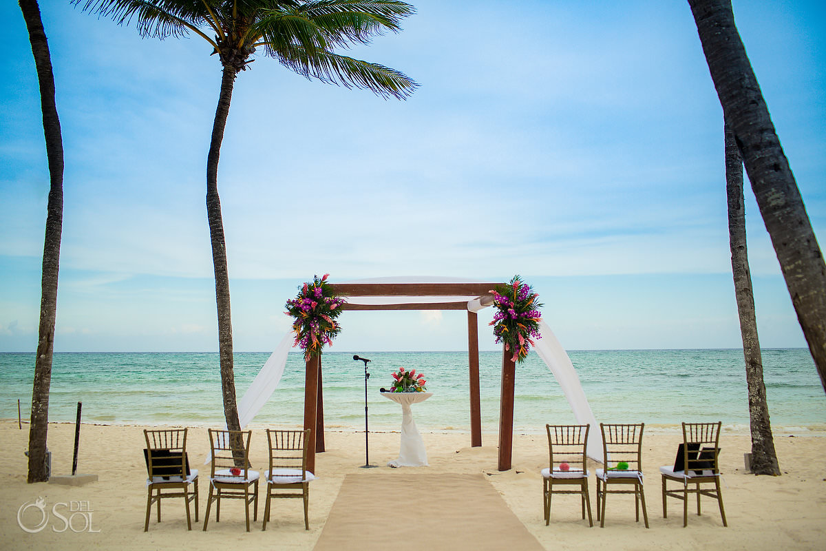 Dreams Tulum Central Beach wedding ceremony setup bright tropical flowers