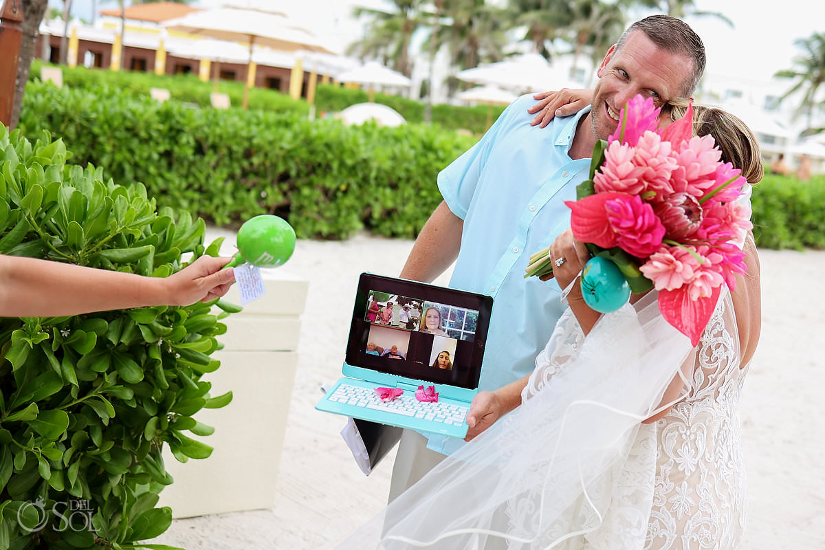 Dreams Tulum Zoom Wedding bride gugs guest holding computer with remote guests