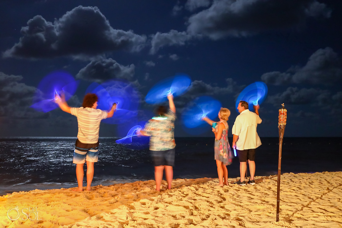 Children playing with glow-sticks Dreams Natura Bonfire Welcome Party Rehearsal Dinner Riviera Cancun Mexico