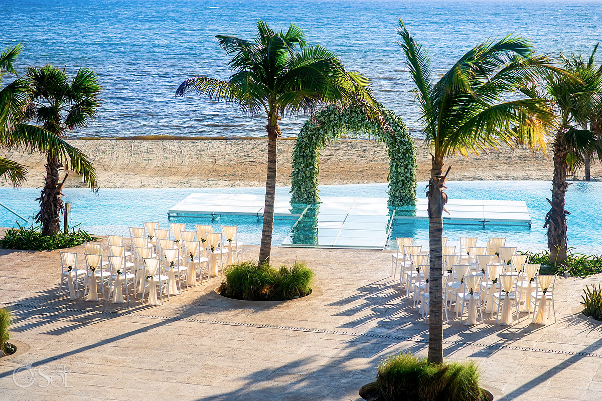 Dreams Natura Wedding flower arch ceremony setup over infinity pool Riviera Cancun Mexico