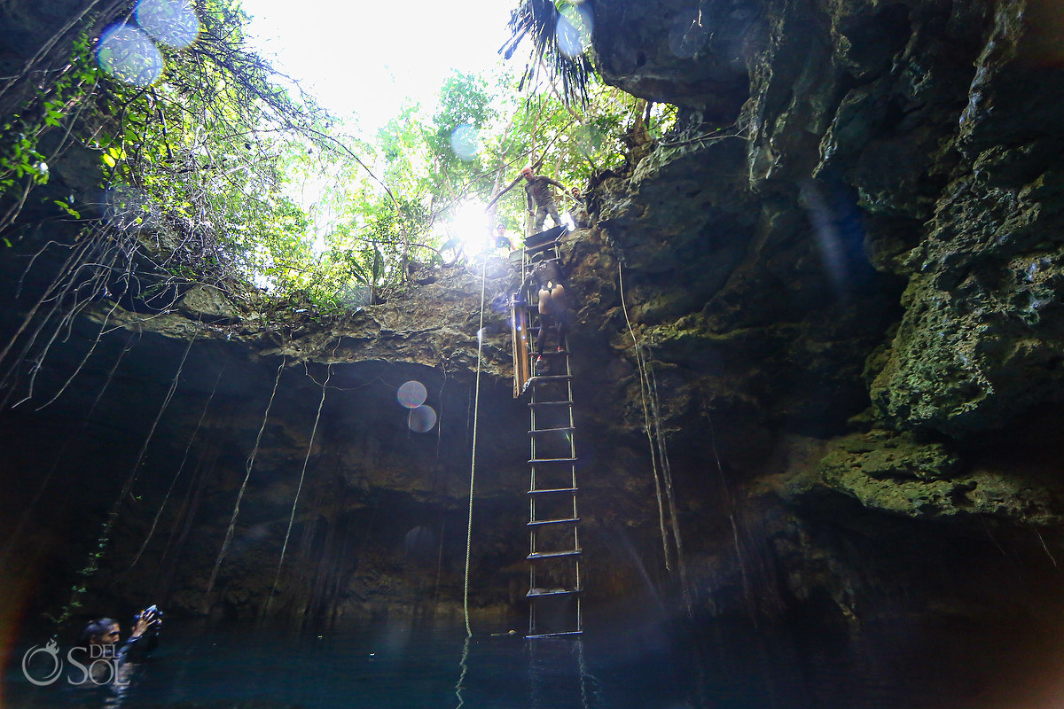 extreme underwater photoshoot behind the scenes climbing down ladder into a cave Riviera Maya Mexico