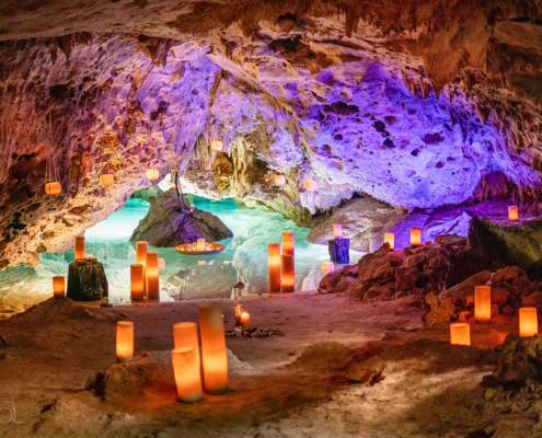 who coordinates Cenote Weddings in Akumal Venue with Candles and colorful lighting