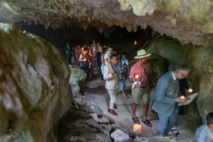 Family treks through underground cave for a wedding ceremony in the cenotes of mexico
