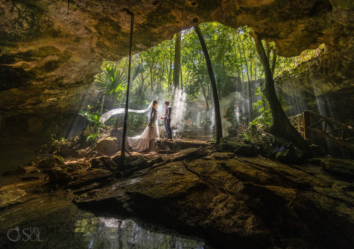 bride and groom posing in underground caves for their Mexico cenote wedding ceremony