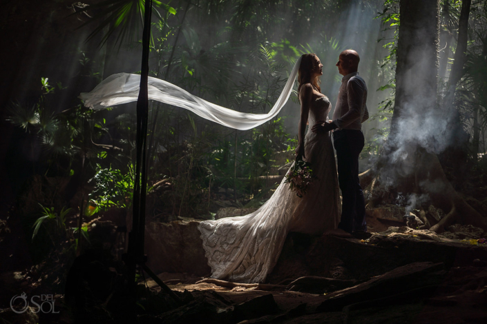 bride and groom posing in underground caves for their Mexico cenote wedding ceremony