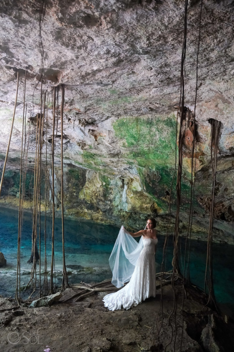 bride posing in underground caves in Mexico cenote wedding ceremony