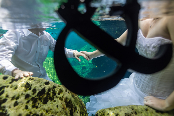 10 Year anniversary trash the dress underwater bride and groom LOVE and ampersand sign