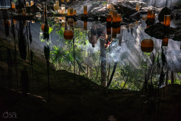 upside down photo reflection of candles floating in a cave Surprise Cenote Proposal Ceremony
