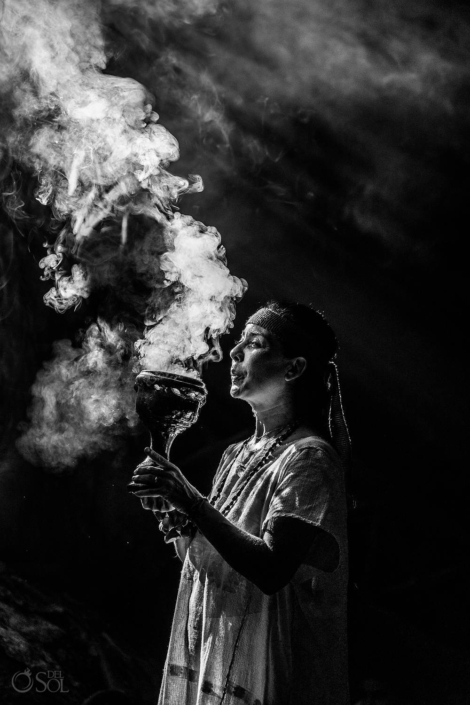 shaman with smoke in a cenote