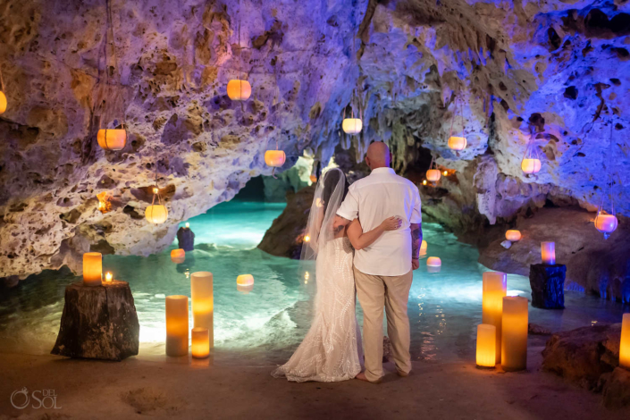 bride and groom posing for a cenote wedding ceremony