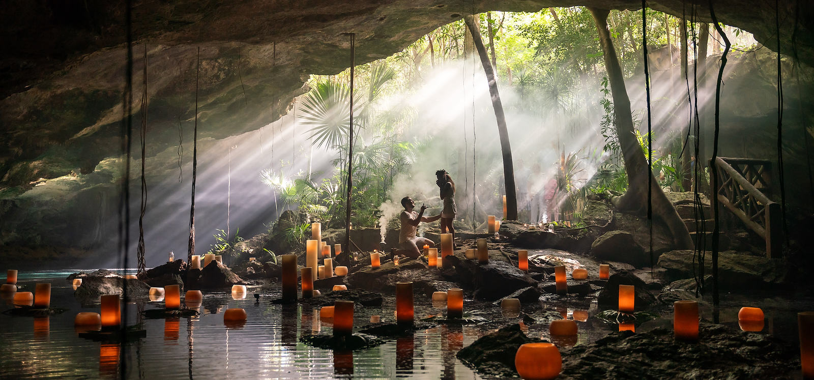 Proposal ideas in Mexico proposing in a cenote with candles and beautiful lighting in a smoke cave