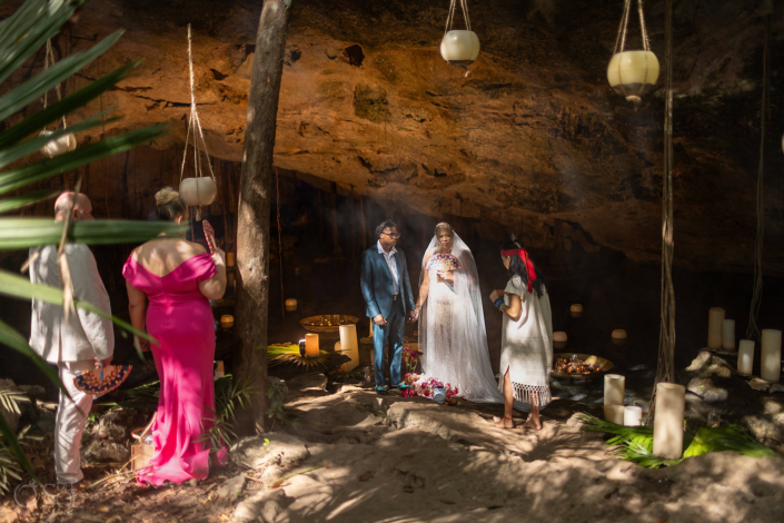 micro cenote ceremony with floating candles and tubular candle decoration