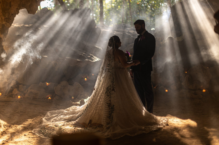 beams of light bride and groom portrait Family Cenote Ceremony in Mexico