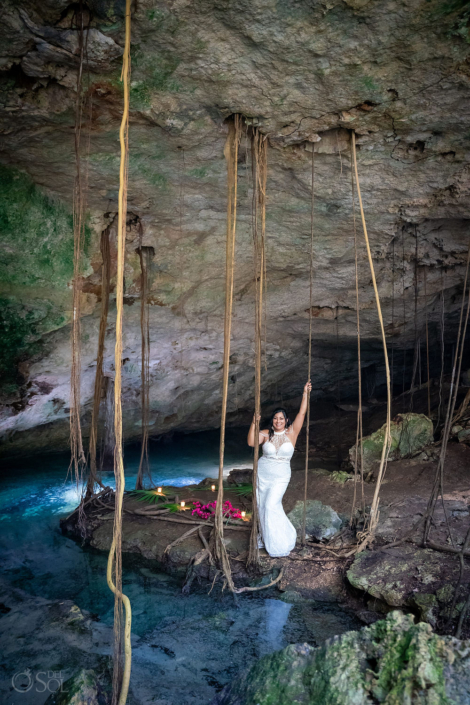 bride posing in a cenote 20 year vow renewal