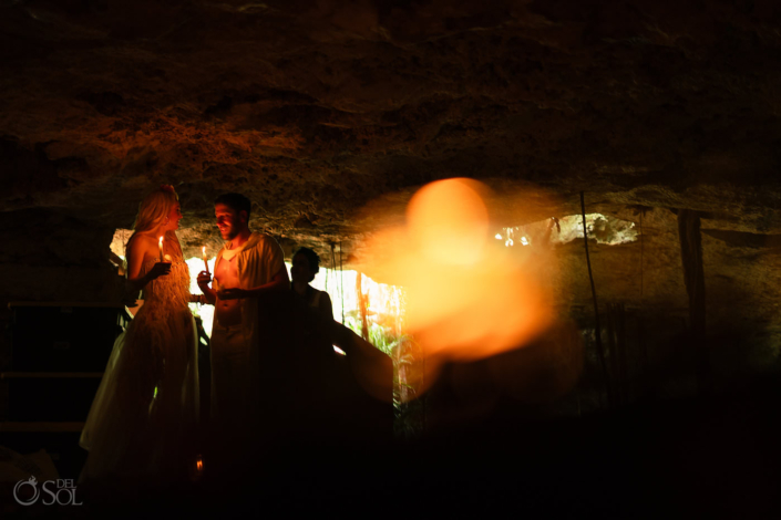 Bride and groom entering a cave for an intimate jungle wedding ceremony