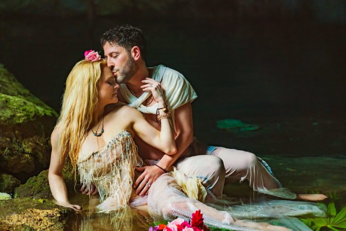 Couple laying in the water for trash the dress elopement photoshoot