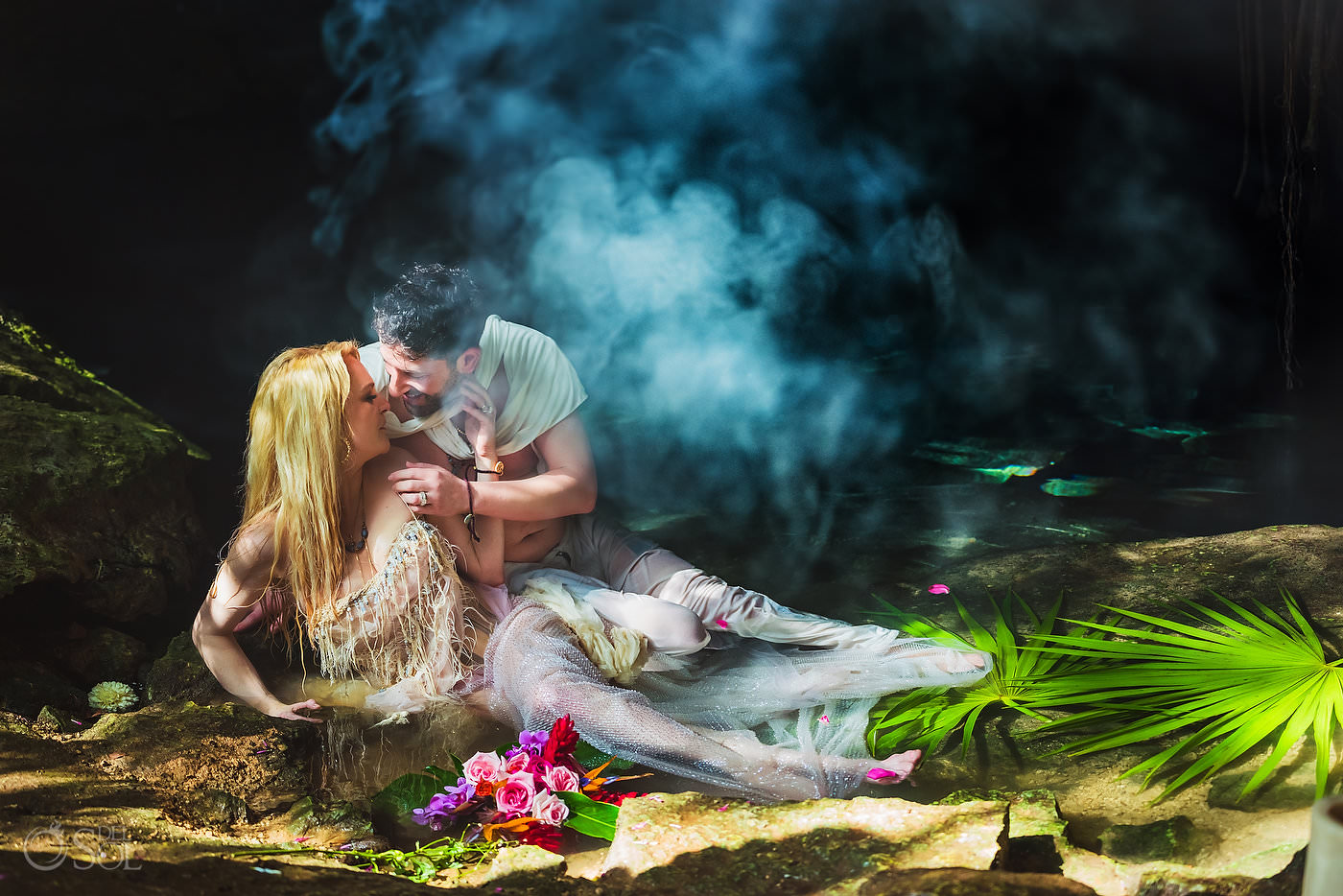 Couple laying in the water for trash the dress elopement photoshoot