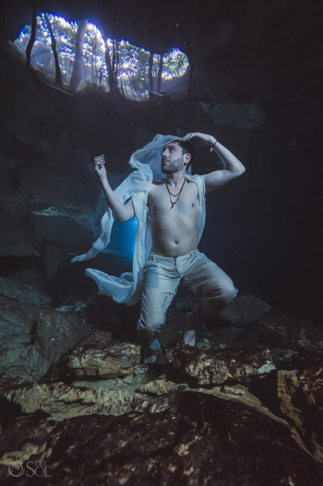 unique groom portrait underwater trash the dress wedding photography Tulum Jungle Cenote