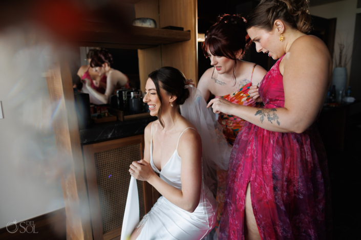 bridesmaids helping bride getting ready Secrets Moxche Wedding