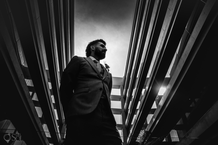 black and white epic portrait of groom getting ready