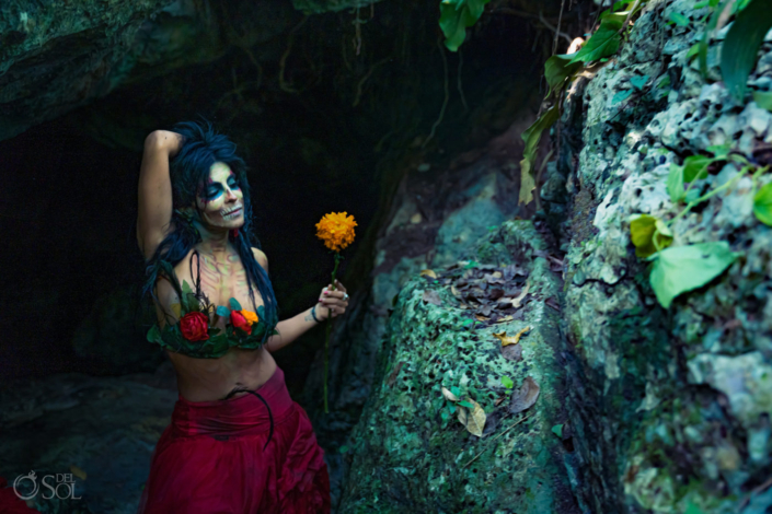 Mexican day of the dead inspired fashion photoshoot model holding marigold