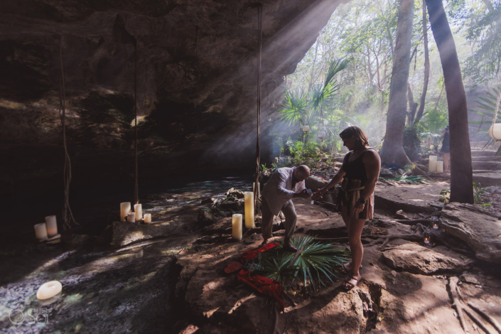 getting down on one knee to propose in a private cenote location in Tulum Mexico